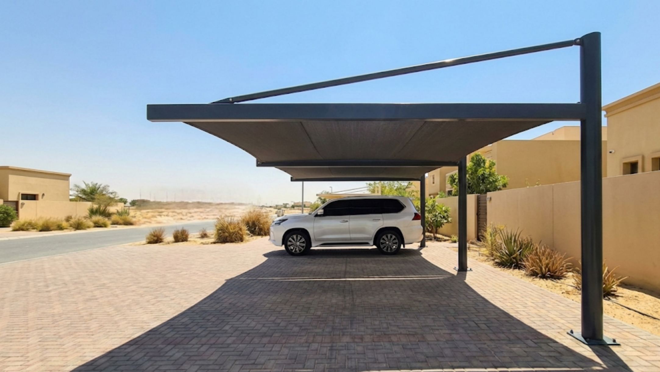 Car under intense UAE sun protected by parking shade